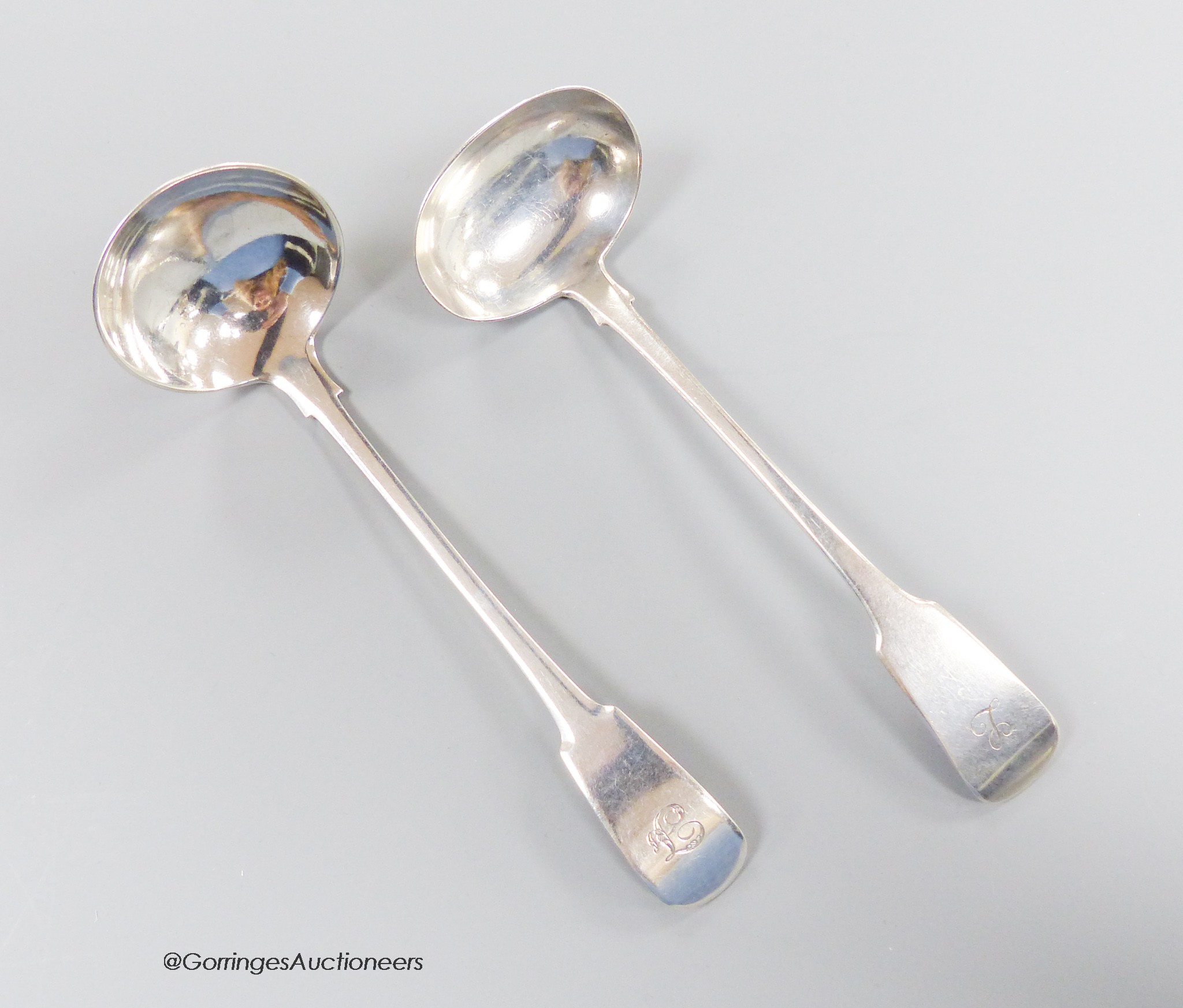 Two 19th century Scottish provincial silver fiddle pattern toddy ladles, George Elder, Banff, c.1825 and William Simpson, Banff, c.1840, longest 16.2cm, 62 grams.